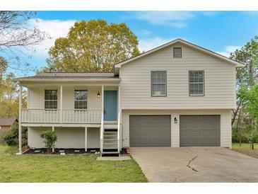 Inviting two-story home featuring a charming front porch and a convenient two-car garage at 111 Evergreen Trl, Cartersville, GA 30121