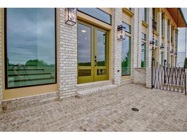 Beautiful entryway features a brick patio, stylish lighting fixtures, and double doors at 190 Rolison Way, Fayetteville, GA 30214