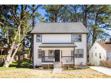 Charming two-story home with a welcoming front porch and beautifully maintained landscaping at 870 Gaston Sw St, Atlanta, GA 30310