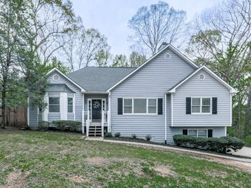 Charming single-Gathering home features a well-maintained lawn and classic architectural details at 841 Butterworth Rd, Canton, GA 30114