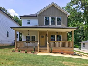 Charming two-story home with a welcoming front porch and well-maintained lawn, ideal for outdoor enjoyment at 158 Hemphill School Rd, Atlanta, GA 30331