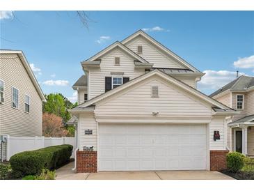 Charming two-story home featuring a two-car garage, manicured landscaping, and vinyl siding at 230 Silver Fox Trl, Dallas, GA 30157