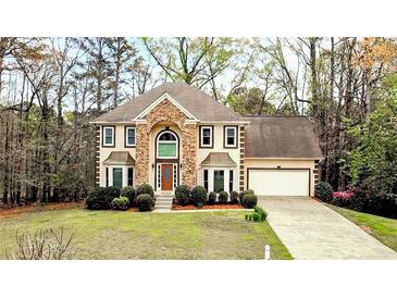 Charming two-story home with a combination of stone and siding, bay windows, and a well-manicured front lawn at 540 Basil Sw Ct, Marietta, GA 30064