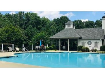Relaxing pool with a covered area that offers shaded seating and a perfect view of the lush greenery at 4062 Vinings Mill Se Trl, Smyrna, GA 30080