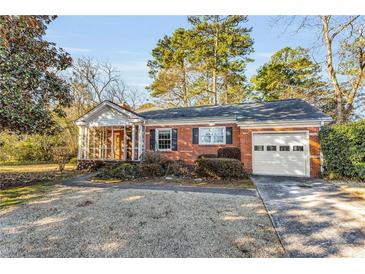 Charming single-story brick home with attached garage and enclosed porch at 948 Sycamore Dr, Decatur, GA 30030