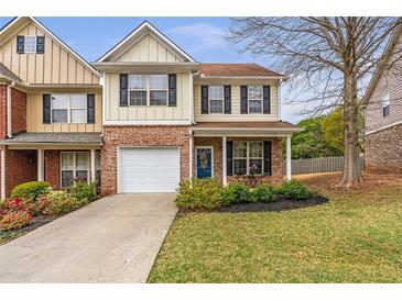Charming two-story home featuring brick accents, a well-manicured lawn, and an attached one car garage at 4037 Hill Station Ct, Sugar Hill, GA 30518