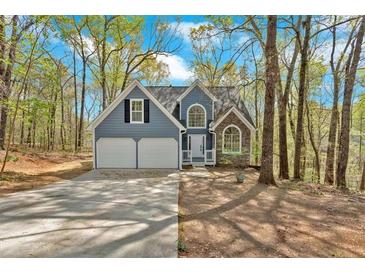 Charming, two-story home with a two-car garage nestled among trees at 4453 Autumn Glo Ct Ct, Douglasville, GA 30135