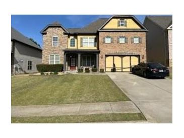 Charming brick home with a well-manicured lawn and two-car garage in suburban neighborhood at 1210 Del Mar Club Dr, Dacula, GA 30019
