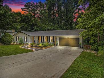 Charming home with a well-manicured lawn, elegant walkway, and attached two-car garage at 2810 Dunnington Cir, Chamblee, GA 30341