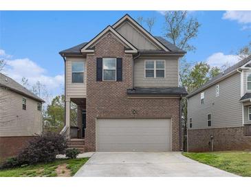 Charming two-story home featuring a brick facade and attached two-car garage at 2039 Theberton Trl, Locust Grove, GA 30248