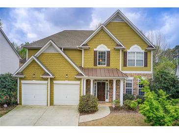 Charming two-story home with a two-car garage, stone accents, and a well-manicured lawn at 4461 Kentland Dr, Acworth, GA 30101