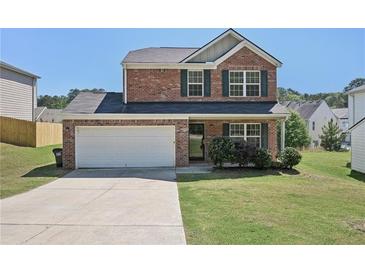 Charming two-story brick home with a well-maintained front yard and an attached two-car garage at 5675 Laurel Ridge Cir, Atlanta, GA 30344