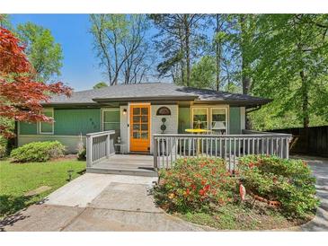 Charming home featuring an inviting front porch with a brightly colored door at 952 Columbia Dr, Decatur, GA 30030