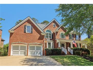 Beautiful brick two-story home with a well-manicured lawn and a two-car garage at 2130 Hollowbrooke Nw Way, Acworth, GA 30101