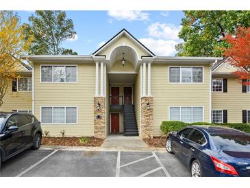 Charming two-story condo with inviting entrance, stone accents, and ample parking spaces at 1468 Briarwood Ne Rd # 810, Brookhaven, GA 30319