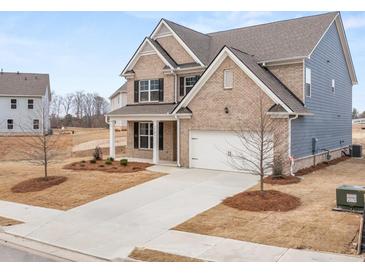 New construction home features a brick facade, attached garage, and professionally landscaped yard at 7170 Linden Dr, South Fulton, GA 30349
