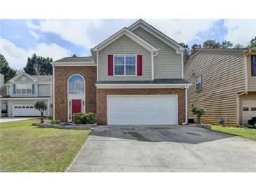 Charming two-story home featuring a brick facade, red shutters, and an attached two-car garage at 2274 Stancrest Ln, Lawrenceville, GA 30044