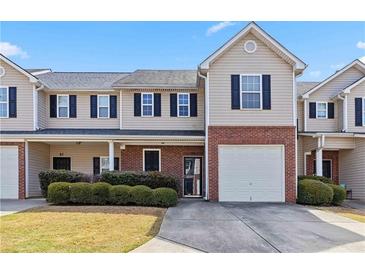 Charming townhome with brick accents, tidy landscaping, and a convenient attached garage at 69 Eagle Glen Dr, Cartersville, GA 30121