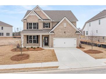 Charming brick home featuring a two-car garage, manicured lawn, and inviting front porch at 7181 Linden Dr, South Fulton, GA 30349