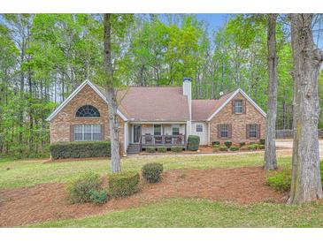 Lovely two-story home with lush landscaping, mature trees, and a brick facade at 270 Albertas Ct, Mcdonough, GA 30252