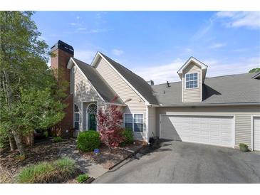 Charming home featuring a well-maintained lawn and a two-car garage with an inviting facade at 1478 Settlers Walk Sw Way, Marietta, GA 30060