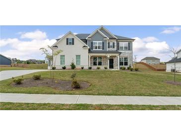 Charming two-story home featuring a combination of painted brick and stone facade with a well-manicured lawn at 133 Bastian Rd, Mcdonough, GA 30252