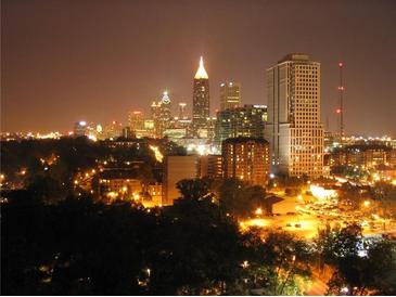 Striking cityscape view at night, featuring illuminated buildings and lush trees at 1101 Juniper Ne St # 1511, Atlanta, GA 30309