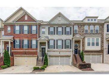 Charming townhomes featuring brick and stone facades, garage parking, and welcoming front entrances at 4836 Se Merriman Se Walk # 23, Smyrna, GA 30080