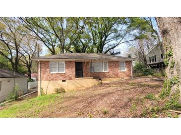 Cozy brick home featuring mature shade trees and a classic design in a quiet residential neighborhood at 340 Adelle Se St, Atlanta, GA 30315