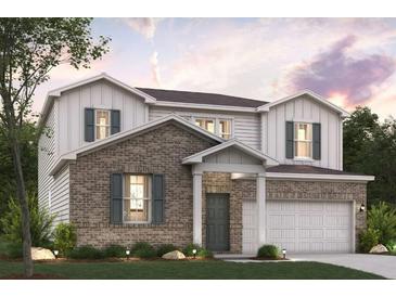 Charming two-story home with brick and siding, complemented by a well-manicured lawn at 7194 Brushwood Bend - Lot 116, Lithonia, GA 30058