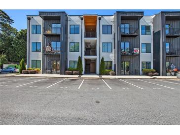 Modern apartment building featuring private balconies, clean architectural lines, and ample parking at 1155 Custer Se Ave # 209, Atlanta, GA 30316