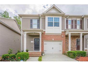 Charming townhome with brick accents, attached garage, and well-maintained landscaping at 2705 Maple Park Pl # 29, Cumming, GA 30041