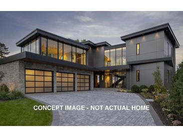 Contemporary home showcasing sleek design, expansive windows, and a spacious three-car garage at 1919 Wellbourne Ne Dr, Atlanta, GA 30324