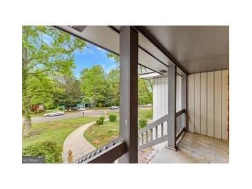 Inviting porch with view of a beautifully landscaped front yard and quiet residential street at 5429 Golfcrest Cir, Stone Mountain, GA 30088