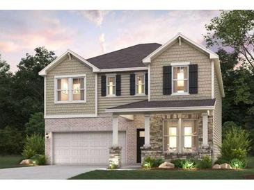 Two-story home featuring stone accents, an attached garage, and landscaped front yard at 7200 Brushwood Bend - Lot 117, Lithonia, GA 30058
