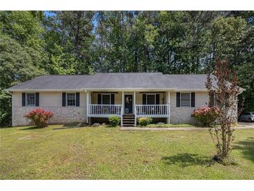 Charming single-story home with a cozy front porch and a well-manicured lawn surrounded by mature trees at 258 Cristy Dr, Dallas, GA 30157