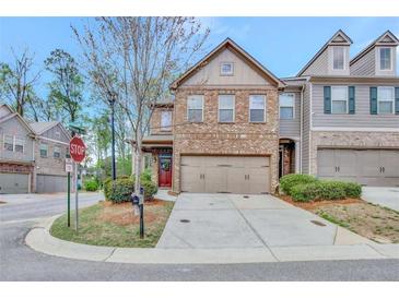Charming brick two-story townhome with a two-car garage, landscaping, and inviting front porch at 4974 Whiteoak Walk Se # 21, Smyrna, GA 30080