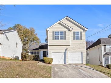 Charming two-story home with a two-car garage and well-maintained front yard at 6422 Phillips Ct, Lithonia, GA 30058