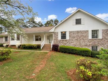 Charming brick home with well-maintained landscaping and inviting front porch at 2610 Betty Jean Dr, Jonesboro, GA 30236