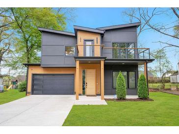 Striking modern home showcasing unique architecture, a two car garage, and a well-manicured lawn at 1598 Athens Ave, Atlanta, GA 30310