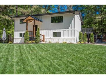 Charming two-story home with a manicured lawn and modern, farmhouse-style architecture at 418 Robinson Rd, Peachtree City, GA 30269