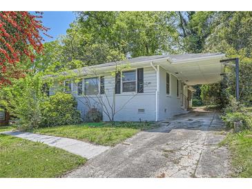 Charming single-story home with a covered carport and a well-maintained front yard at 1105 S Parkwood Dr, Forest Park, GA 30297