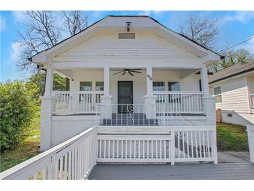 Charming front exterior with inviting porch, white brick accents, and an inviting entry at 934 Joseph E Boone Nw Blvd, Atlanta, GA 30314