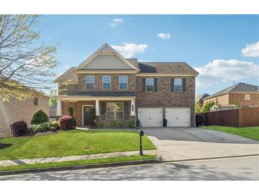 Charming two-story brick home with a well-manicured lawn and a two-car garage at 368 Sawyer Meadow Way, Grayson, GA 30017