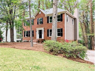 Charming brick two-story home with black shutters and a well-manicured lawn at 2863 Landing Dr, Marietta, GA 30066