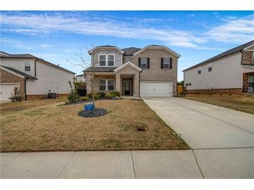 Charming two-story home with a brick facade and well-maintained lawn at 787 Milo Bay Street, Loganville, GA 30052