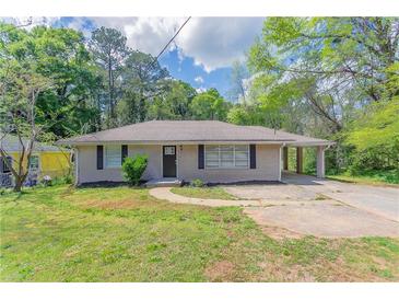 Charming ranch-style home with a welcoming front yard and a convenient carport at 1973 Columbia Dr, Decatur, GA 30032