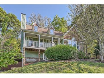 Charming home featuring a welcoming front porch, dormer windows and a beautiful stone chimney at 24 Laurel Ne Way, White, GA 30184