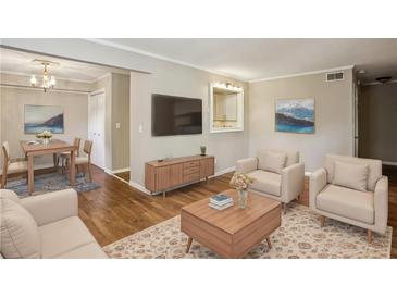 Inviting living room featuring hardwood floors, a neutral color palette, and comfortable seating arrangement at 3091 Colonial Way # F2, Atlanta, GA 30341