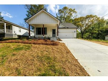 Charming new construction home with a white exterior, covered porch, and an attached garage at 2286 Carver Nw Dr, Atlanta, GA 30314